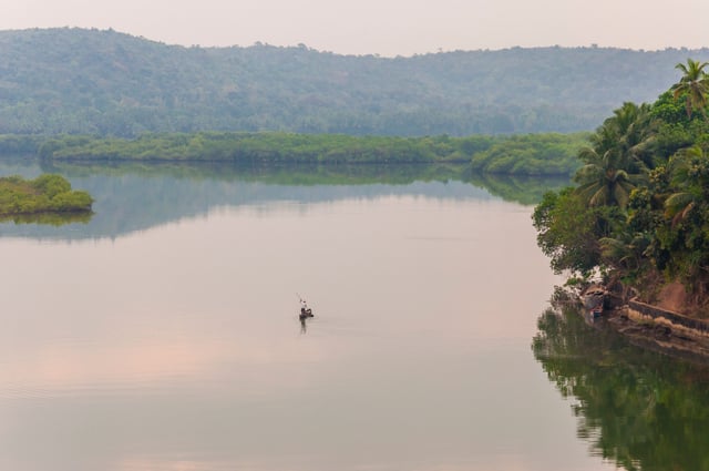 A Boat Paddling Through The River