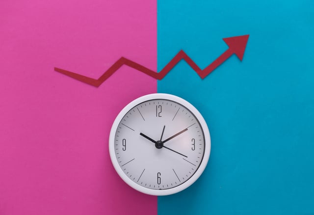 A clock showing the time with a colourful background