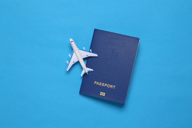 A toy plane on top of a passport