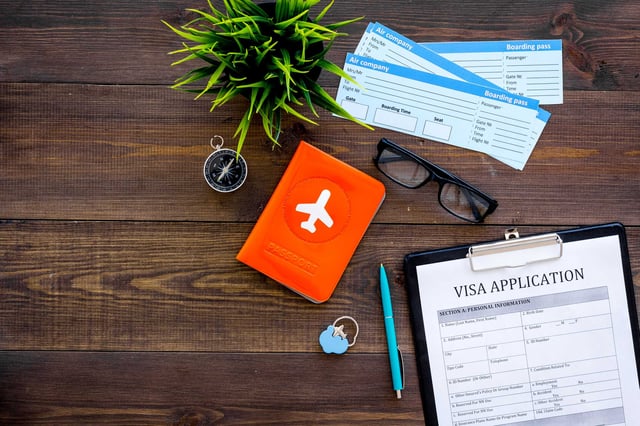 A visa application with a passport and boarding passes