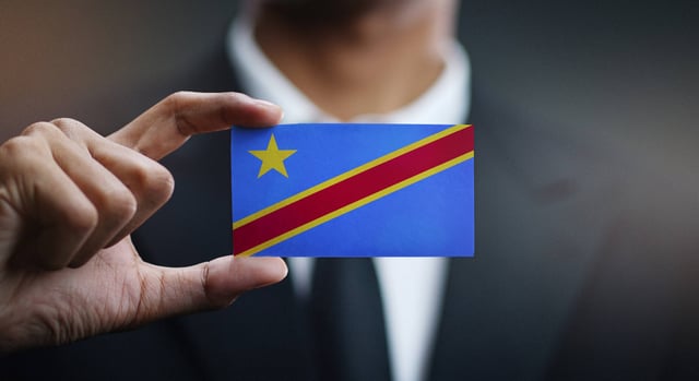 Businessman holding up a DRC flag as a card