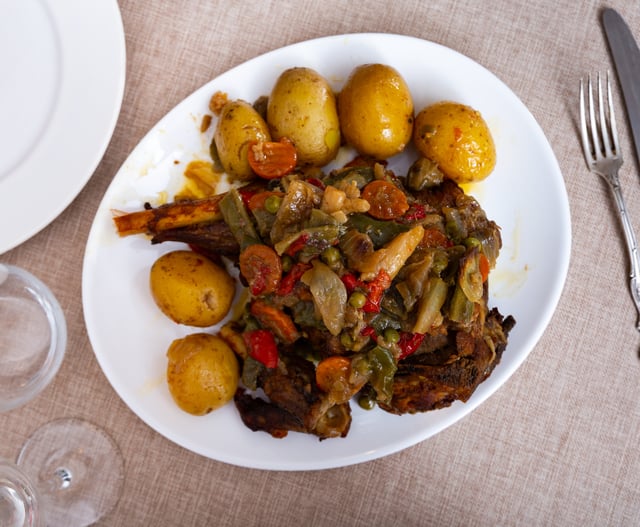 cooked mutton and baked potato with vegetables