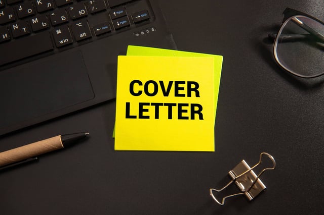 Cover Letter is written on a sticky note on a laptop