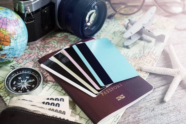Credit cards on top of a passport on a map