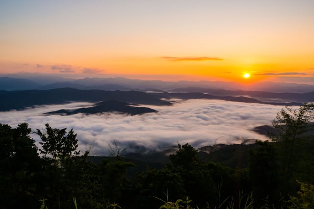 Mountain Ranges Overlooking Clouds And Sunset