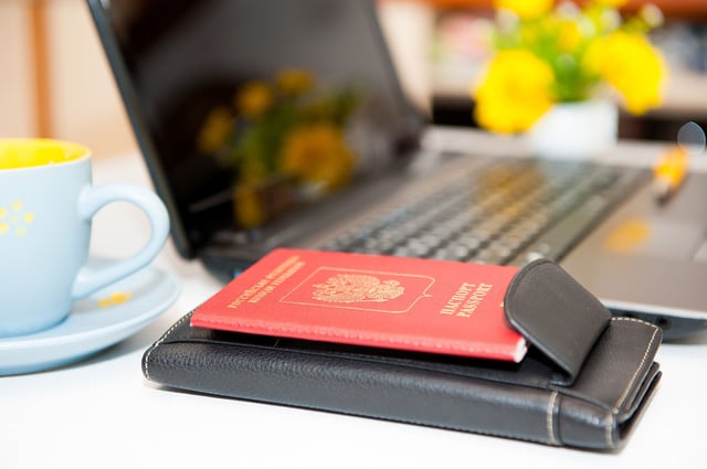 Passport next to a laptop