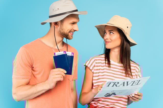 Tourists looking at a map with two passports