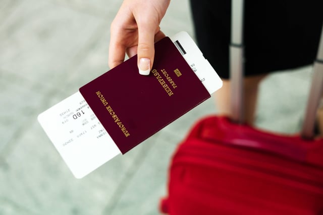 Woman With Passport And Airline Tickets At An Airport Waiting For Her Departure On Holiday