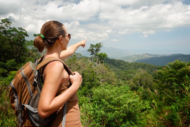 Young Woman With Backpacker Standing On Top Of The Mountain