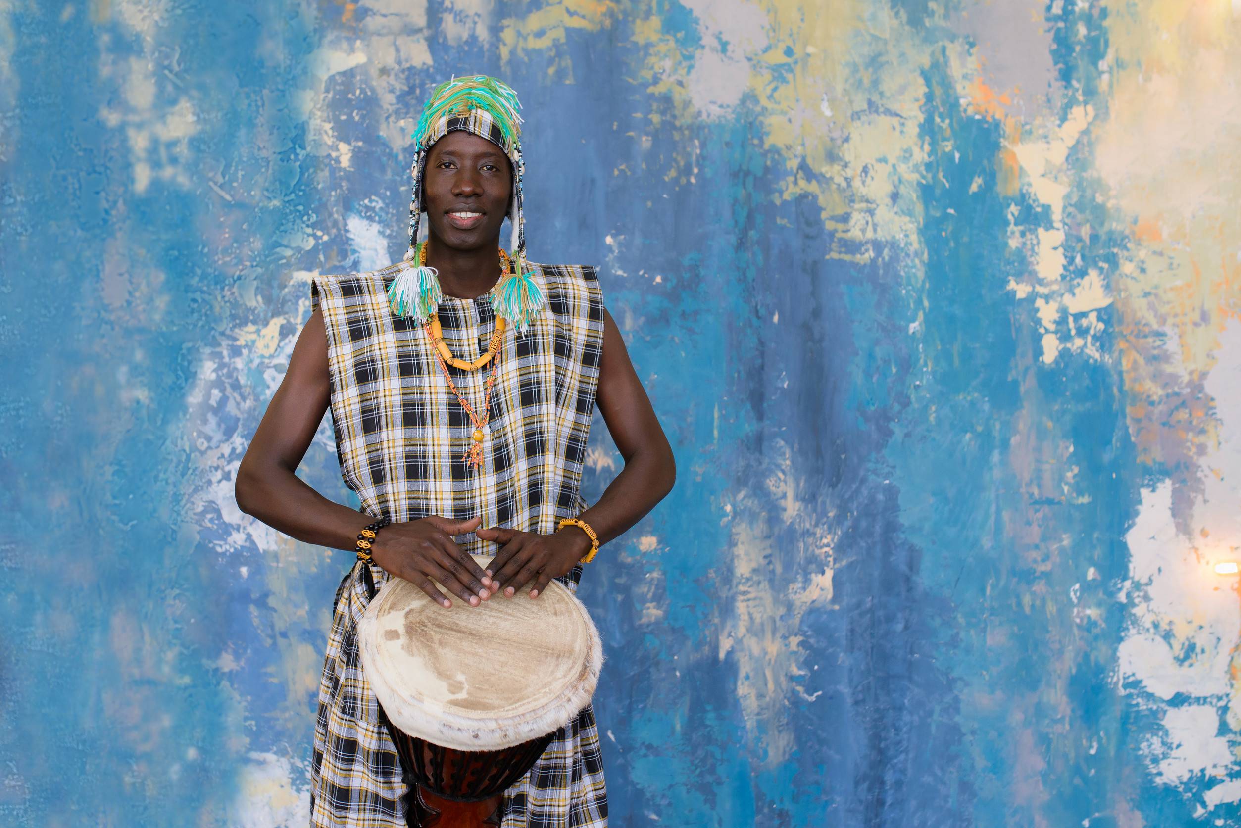 African Man Playing Djembe