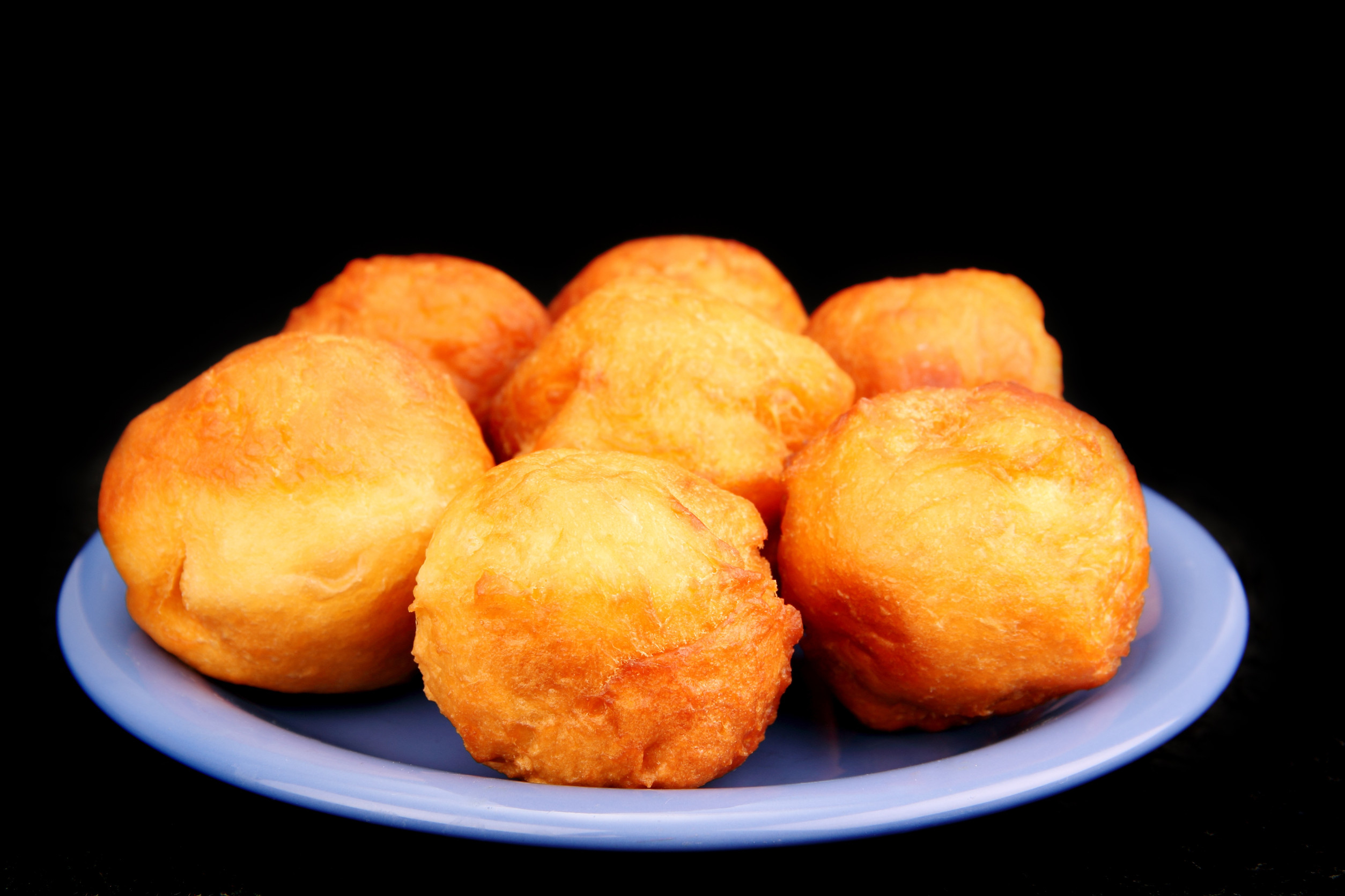 Several Round Of Donuts On A Ceramic Plate